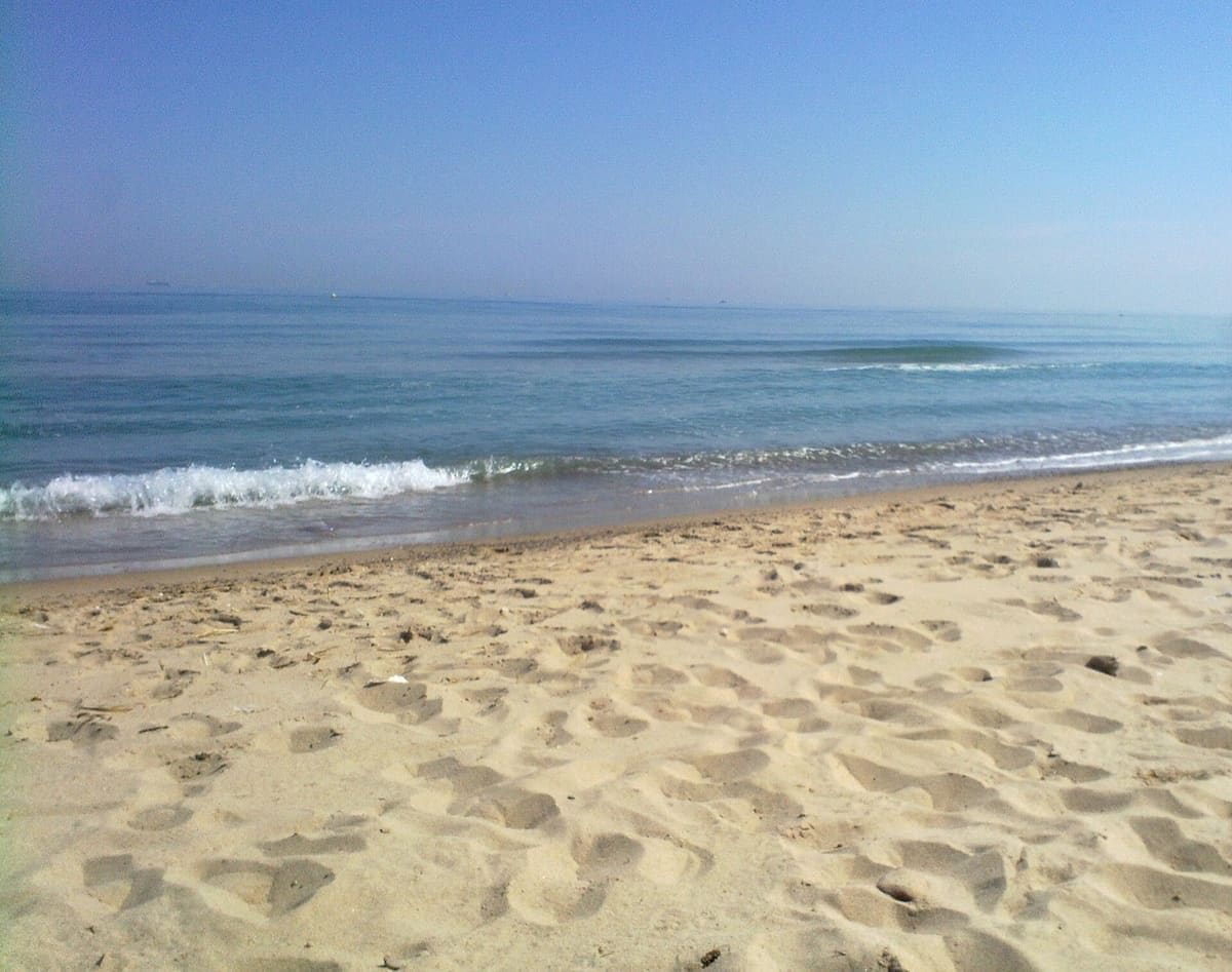 Natural sandy beach and Mediterranean water at Playa de la Devesa near Valencia