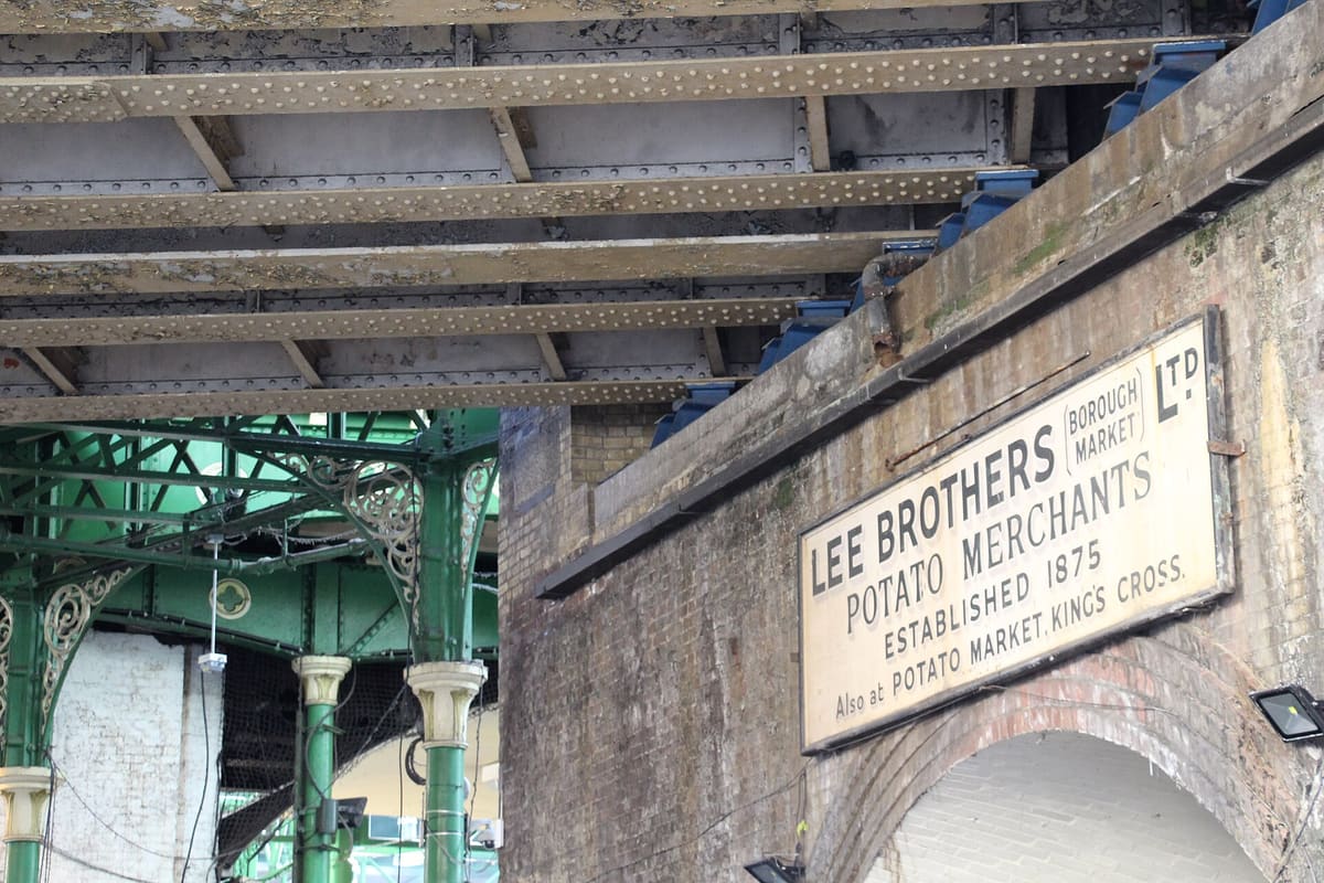 Historic railway arches and market sign at Borough Market in London